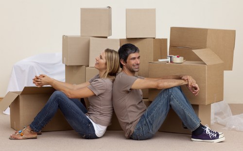 Movers carrying household items in a flat removal