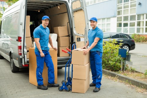 Removal team handling furniture in a London flat
