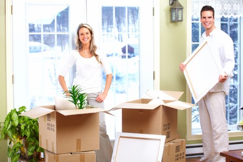 Packed moving boxes and furniture prepared for a flat move in Earls Court